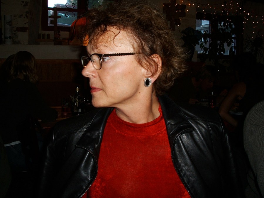 Photograph of Barbara Czarniawska, in profile, wearing glasses and a leather jacket.