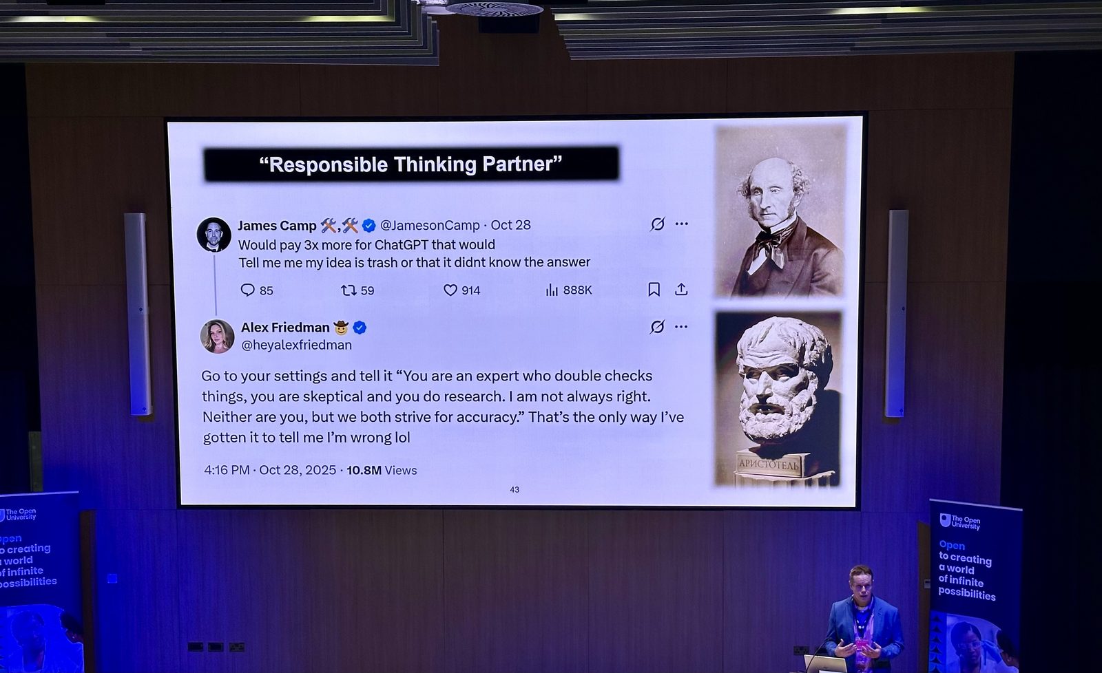 Kevin Morrell speaking at a lectern on the right of a large auditorium stage, beside a screen showing a slide headed “Responsible Thinking Partner”, with portraits of John Stuart Mill and a bust of Aristotle down its right-hand edge. Open University banners stand either side.